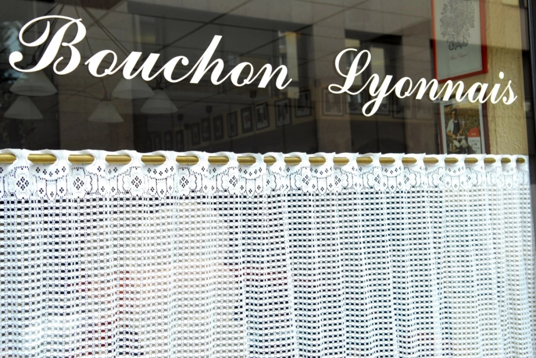 The exterior of a restaurant with the text Bouchon Lyonnais on its